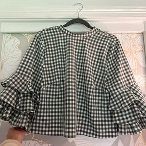 a green and white plaid blouse
